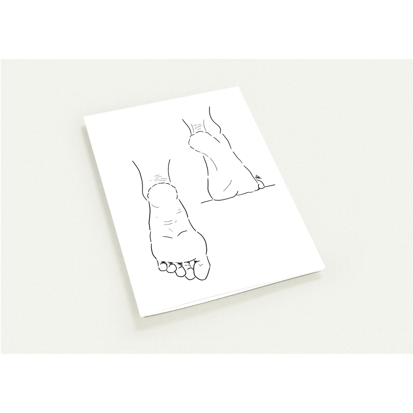 White card with black line drawings of feet on a white background