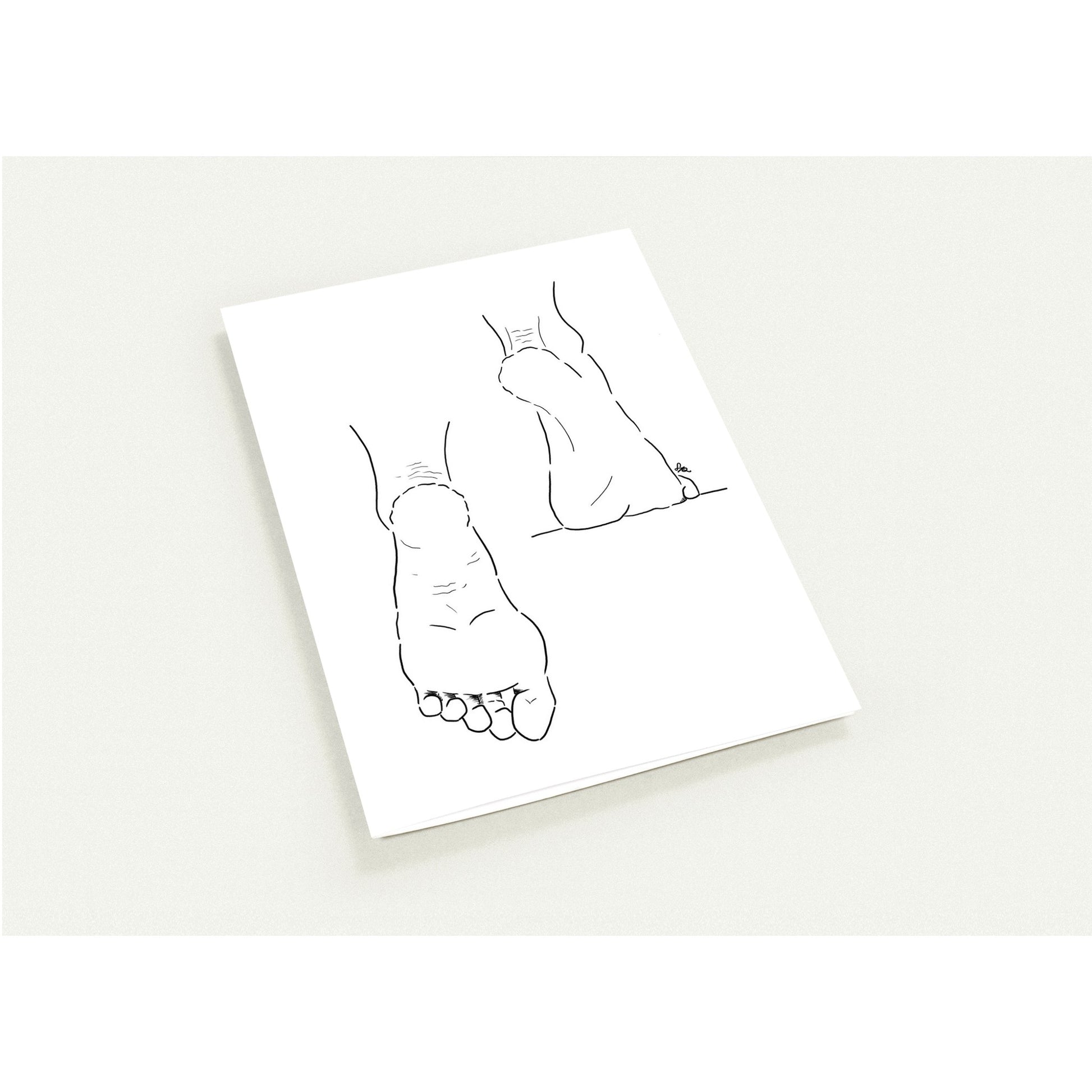 White card with black line drawings of feet on a white background