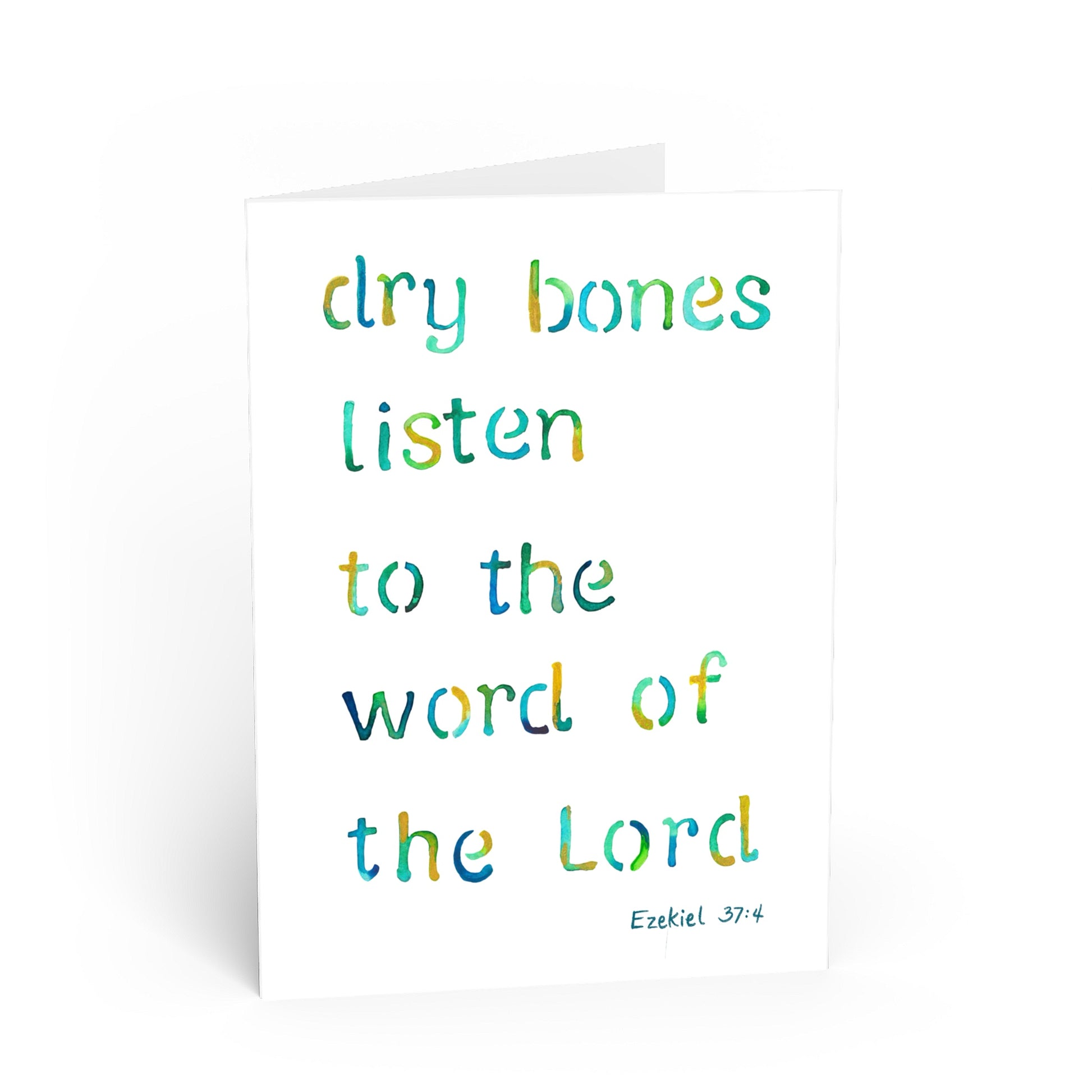 A white greeting card with a watercolor-style quote reading 'dry bones listen to the word of the Lord' in blue and green lettering, with 'Ezekiel 37:4' printed at the bottom right.