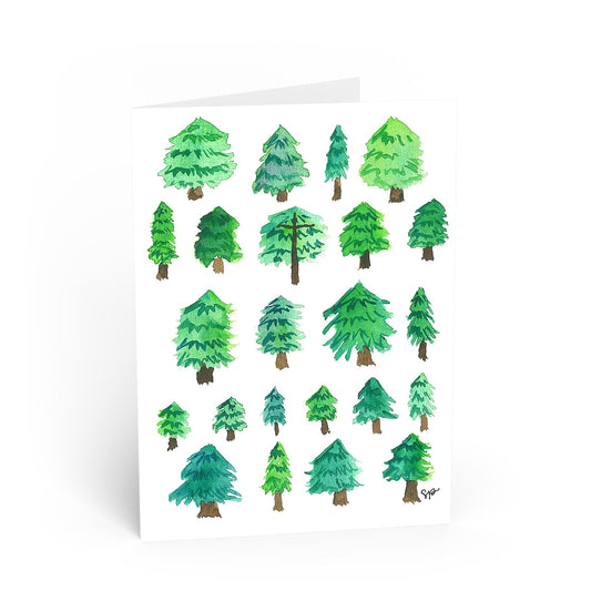 A white greeting card featuring a watercolor illustration of multiple green pine trees, shown standing against a clean white background.