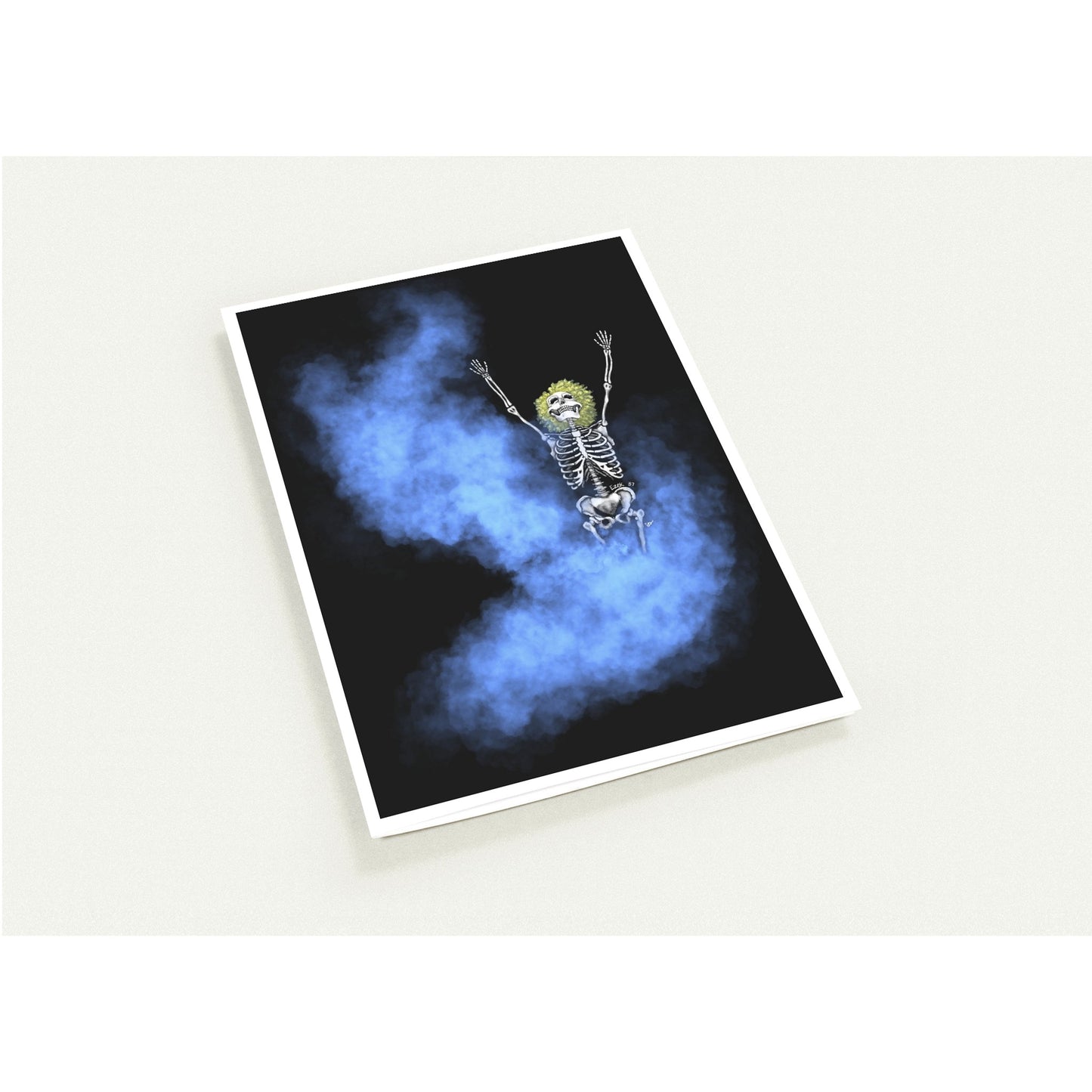 A rectangular art card with a white border, shown at an angle on a light beige background. The artwork features a cartoon skeleton with raised arms floating or falling through swirling blue smoke on a black background.