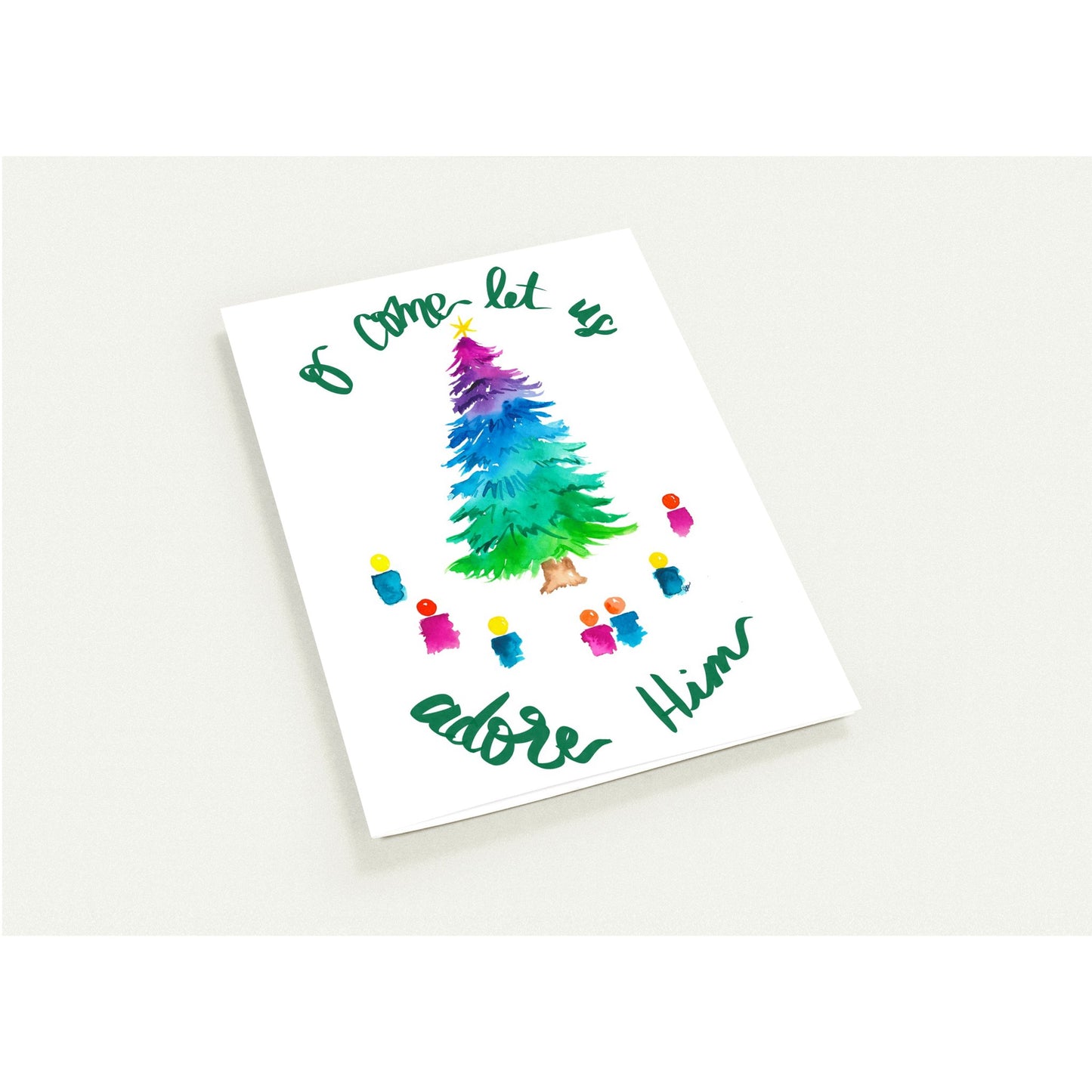 Christmas-themed card with colorful tree and text on a white background
