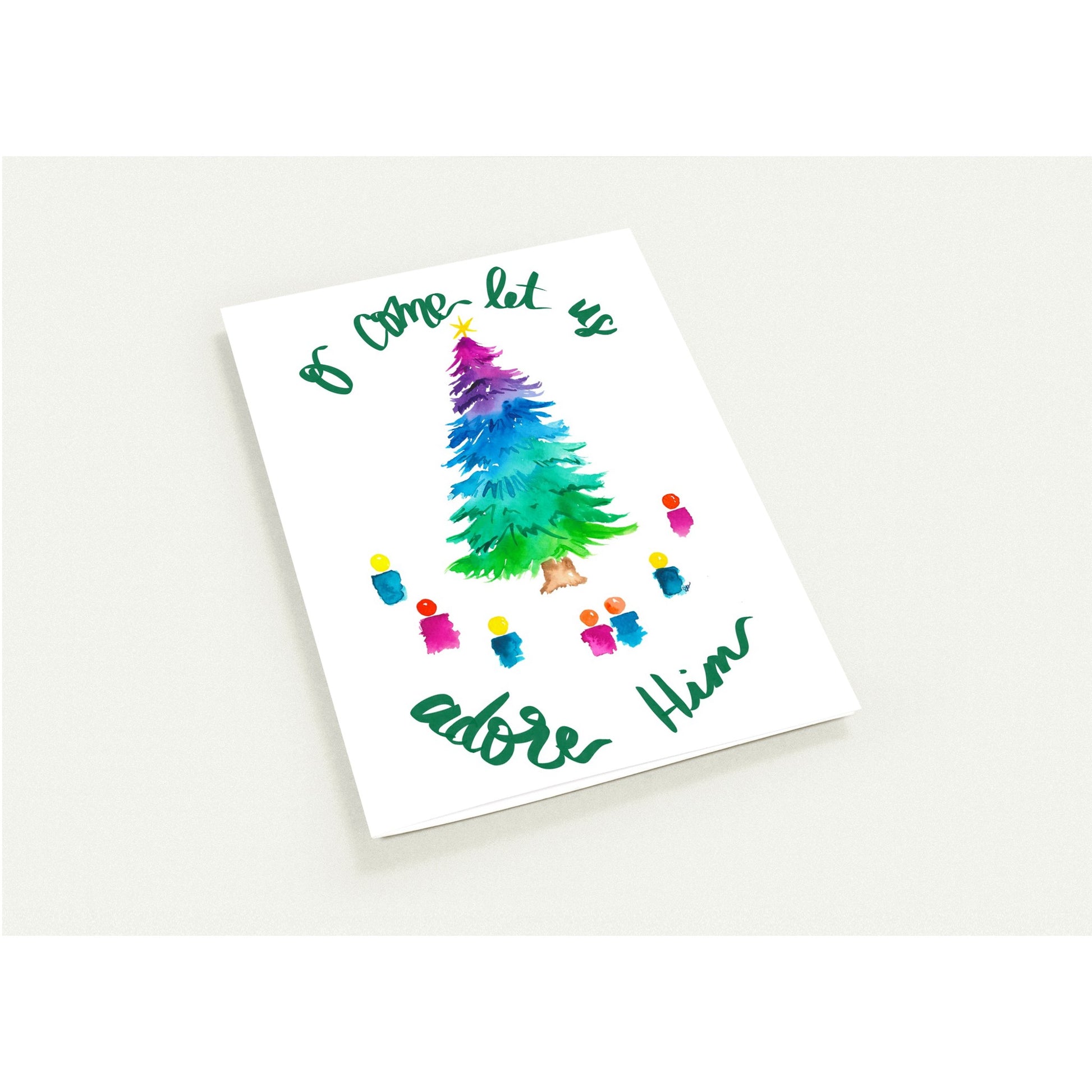 Christmas-themed card with colorful tree and text on a white background
