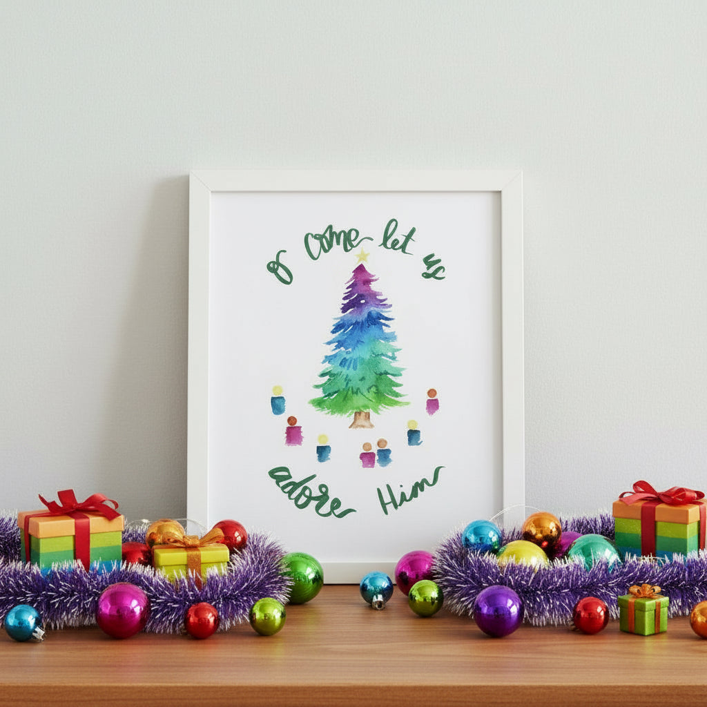 Framed artwork of multi colored Christmas tree with text “O come let us adore Him” with colorful decorations on a wooden surface.